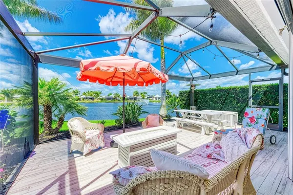 a view of a patio with a dining table and chairs under an umbrella