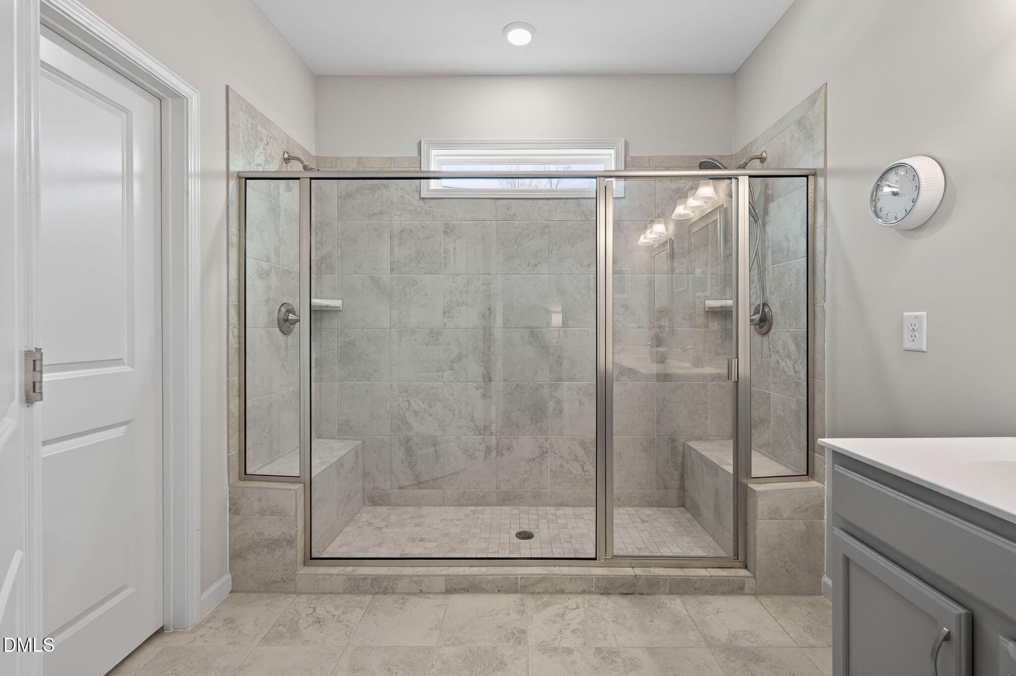 528 Spring Flower Court Cary, NC 27511 - Photo 26 of 51 a bathroom with a glass shower door