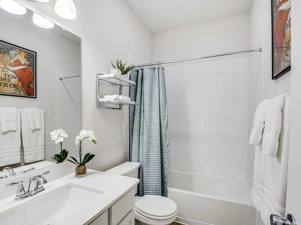 8409 Prairie Rye Drive Lago Vista, TX 78645 - Photo 13 of 17 a bathroom with a sink a toilet and shower
