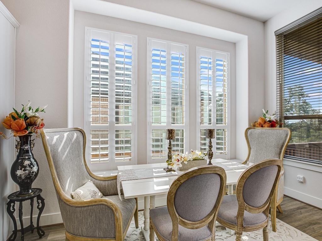 8409 Prairie Rye Drive Lago Vista, TX 78645 - Photo 7 of 17 a dining room with furniture a chandelier and wooden floor