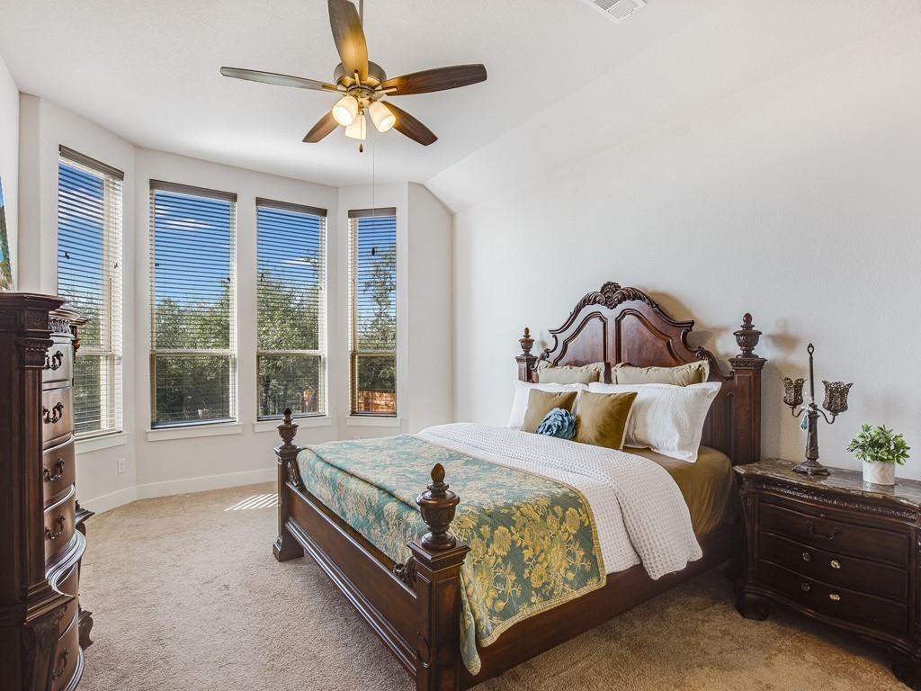8409 Prairie Rye Drive Lago Vista, TX 78645 - Photo 8 of 17 a bedroom with a bed and a large window