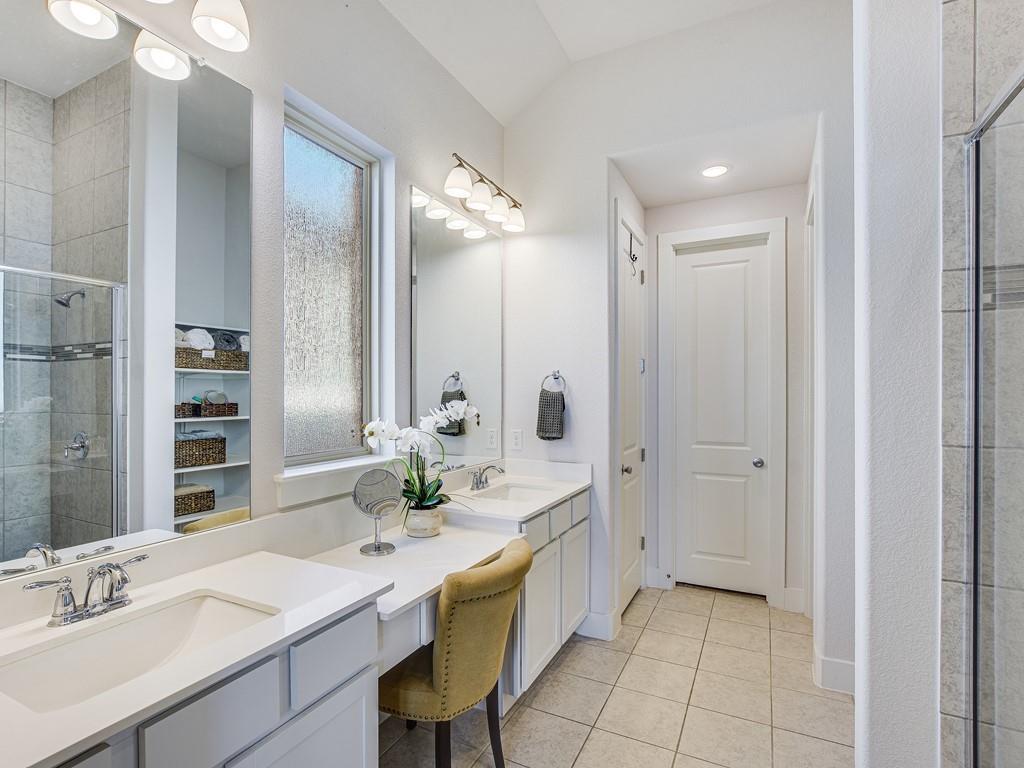 8409 Prairie Rye Drive Lago Vista, TX 78645 - Photo 9 of 17 a spacious bathroom with a granite countertop sink a mirror and a shower