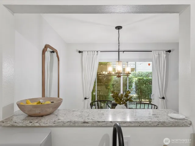 a bathroom with a granite countertop sink and a large mirror