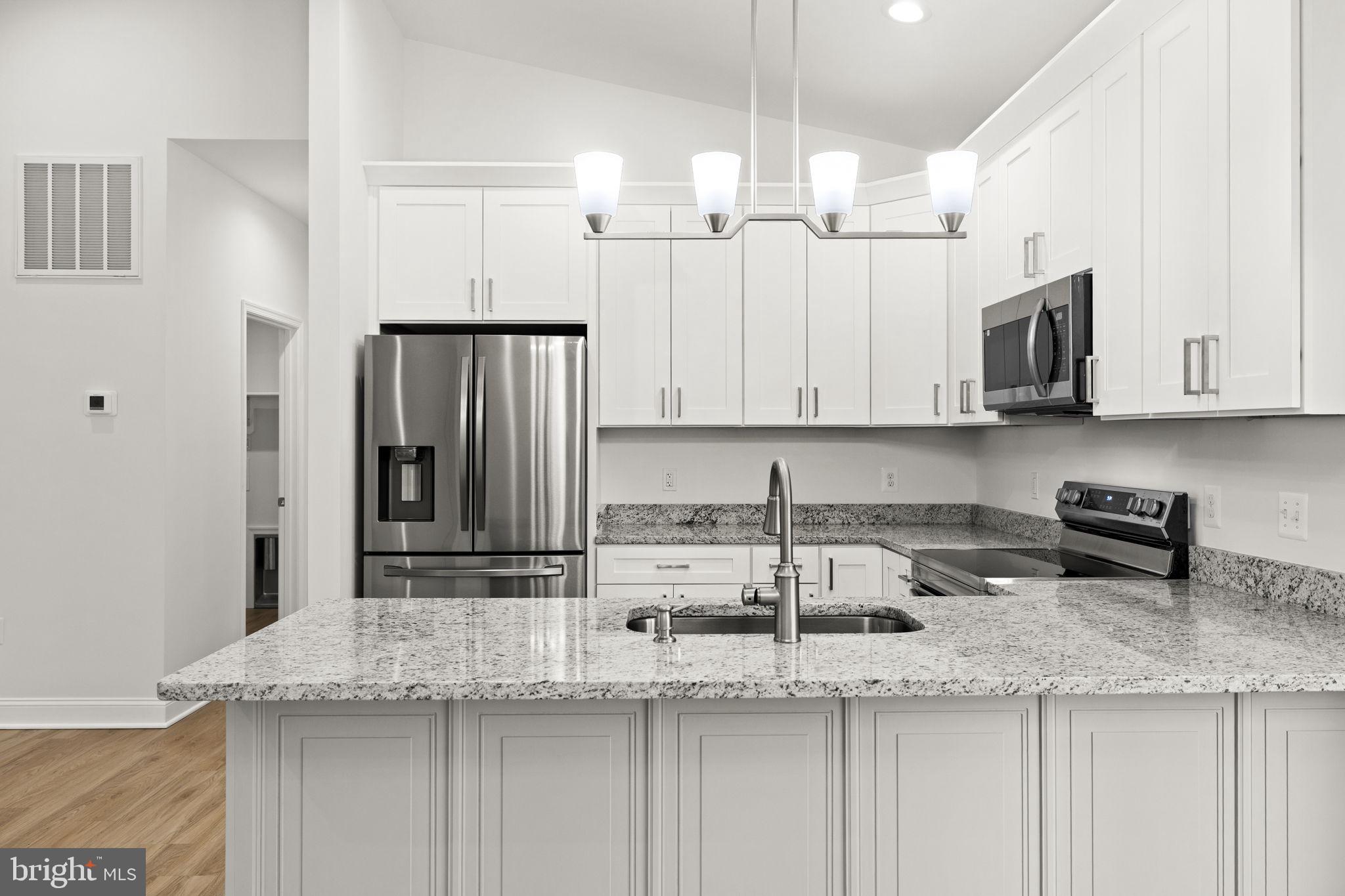 27 Colony Way Montross, VA 22520 - Photo 13 of 90 a kitchen with stainless steel appliances granite countertop a sink a stove and a refrigerator