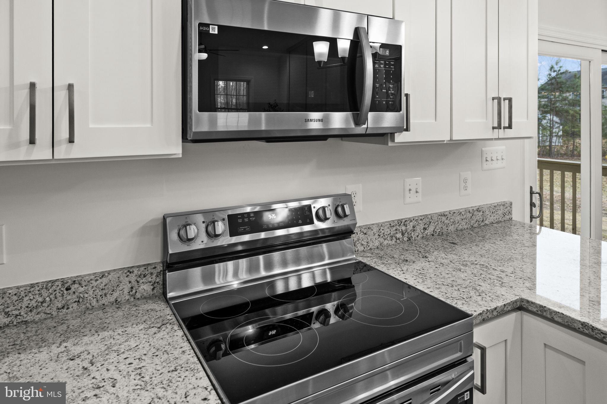 27 Colony Way Montross, VA 22520 - Photo 17 of 90 a kitchen with stainless steel appliances granite countertop a stove and a microwave