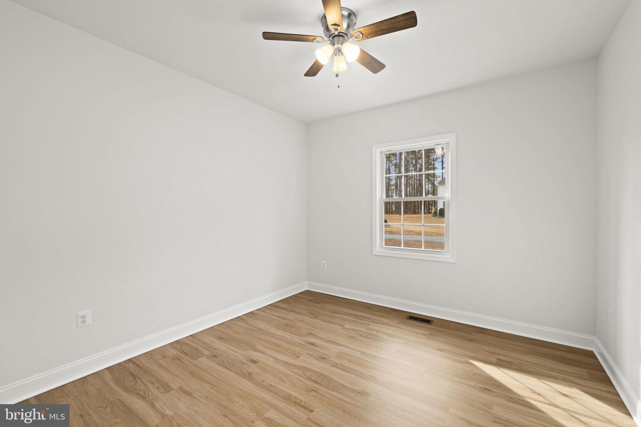 27 Colony Way Montross, VA 22520 - Photo 29 of 90 a view of a room with wooden floor and windows in a room