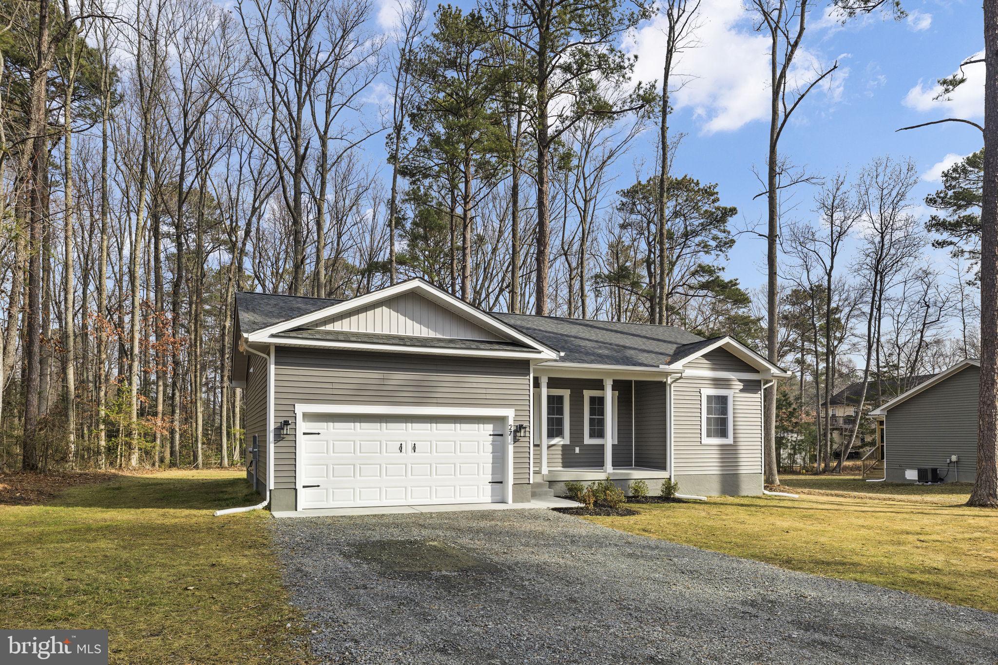 27 Colony Way Montross, VA 22520 - Photo 31 of 90 a front view of a house with a yard and garage