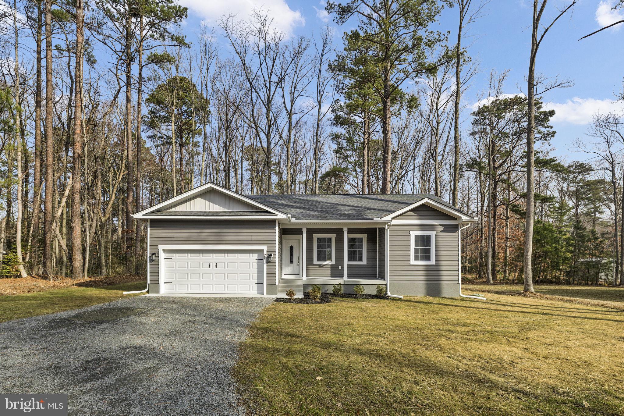 27 Colony Way Montross, VA 22520 - Photo 33 of 90 a front view of a house with a yard and garage