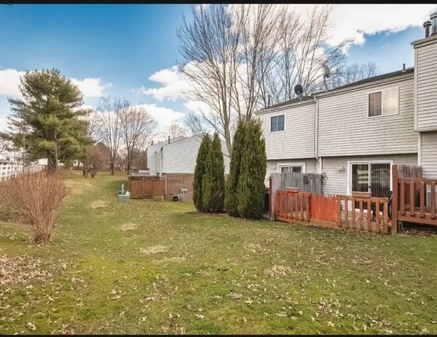 a view of a house with backyard and sitting area