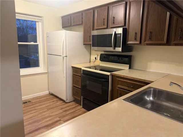 a kitchen with a refrigerator stove and microwave