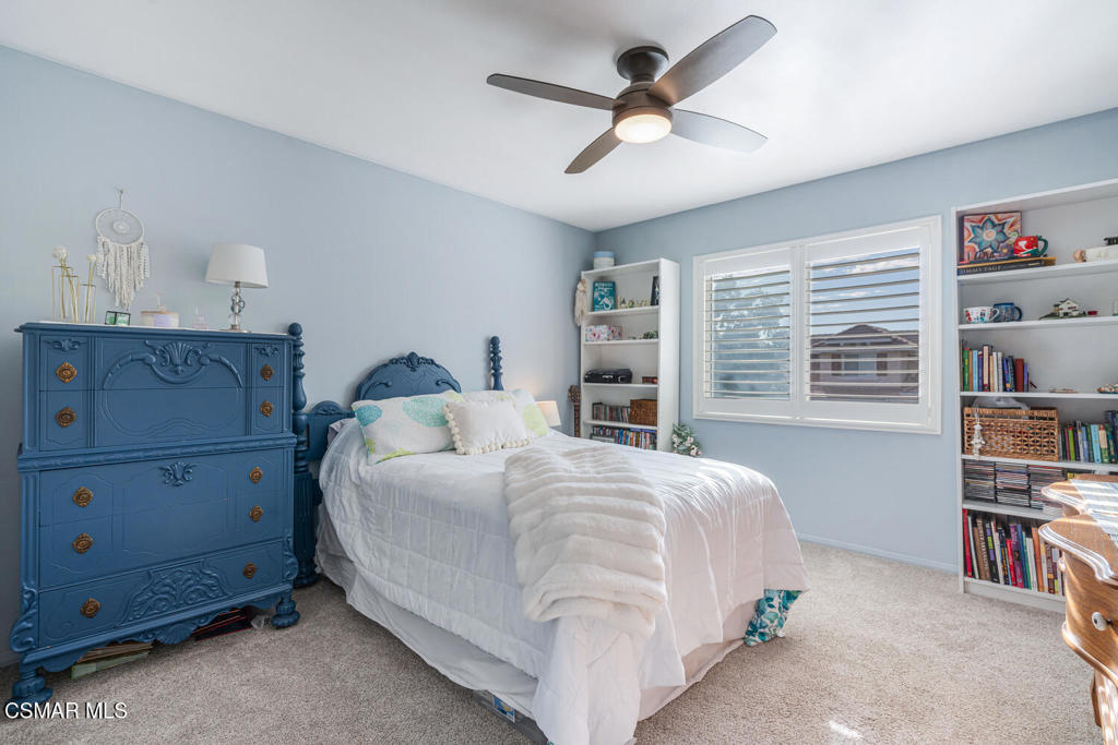 2040 Freesia Avenue Simi Valley, CA 93063 - Photo 21 of 26 a bedroom with a bed a book shelf and a window