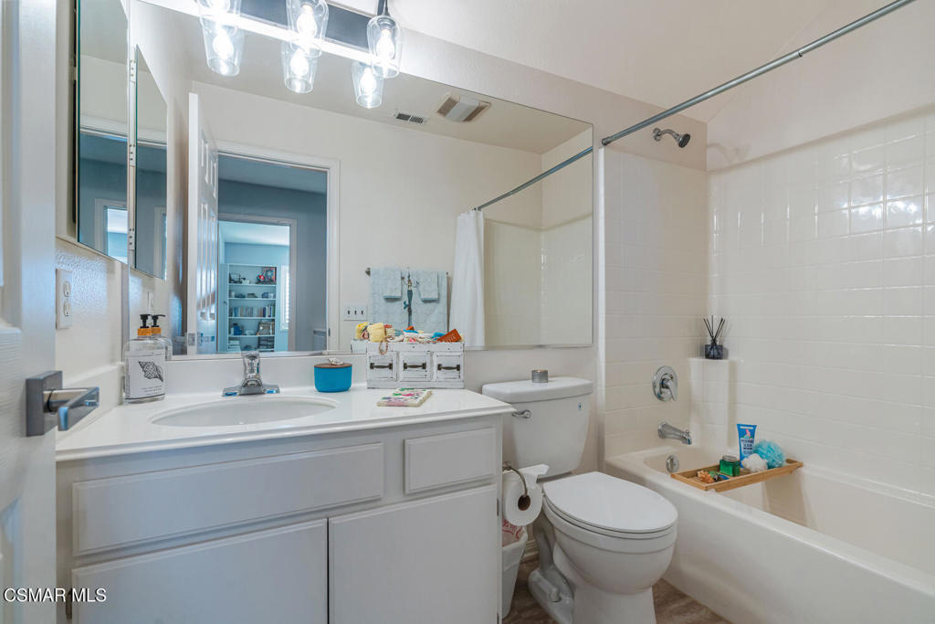 2040 Freesia Avenue Simi Valley, CA 93063 - Photo 22 of 26 a bathroom with a double vanity sink toilet and shower