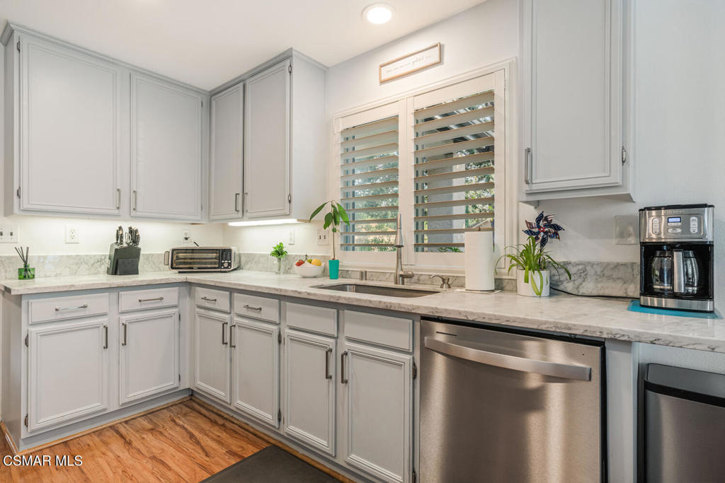 2040 Freesia Avenue Simi Valley, CA 93063 - Photo 5 of 26 a kitchen with stainless steel appliances granite countertop a sink a stove and cabinets