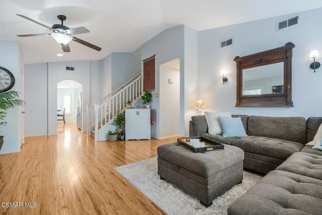 a living room with furniture and wooden floor