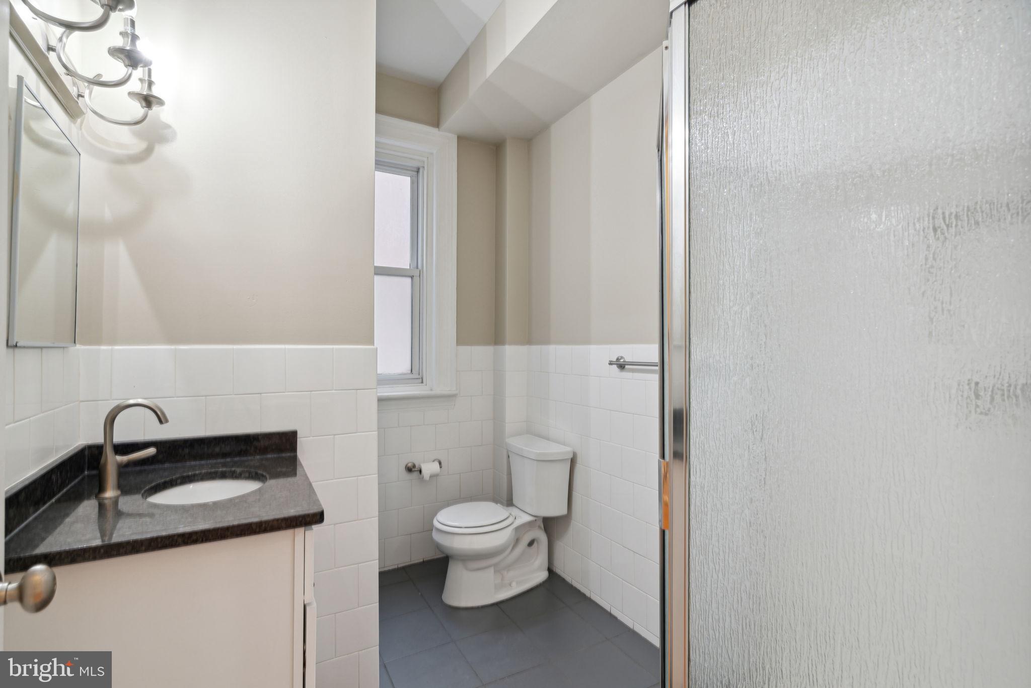 1955 Locust Street, Unit 2R Philadelphia, PA 19103 - Photo 12 of 19 a bathroom with a toilet sink and mirror