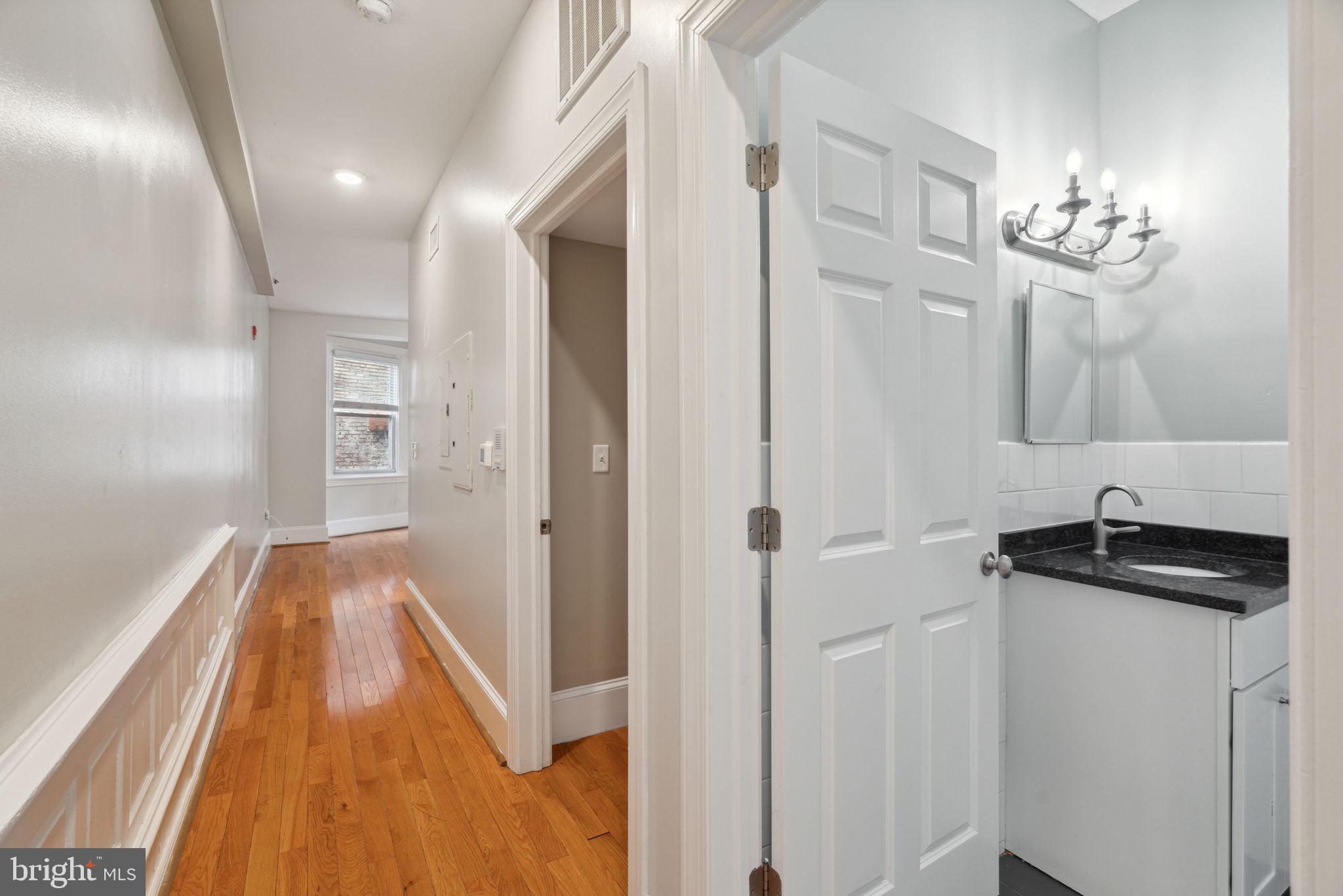 1955 Locust Street, Unit 2R Philadelphia, PA 19103 - Photo 2 of 19 a view of a hallway with wooden floor and staircase