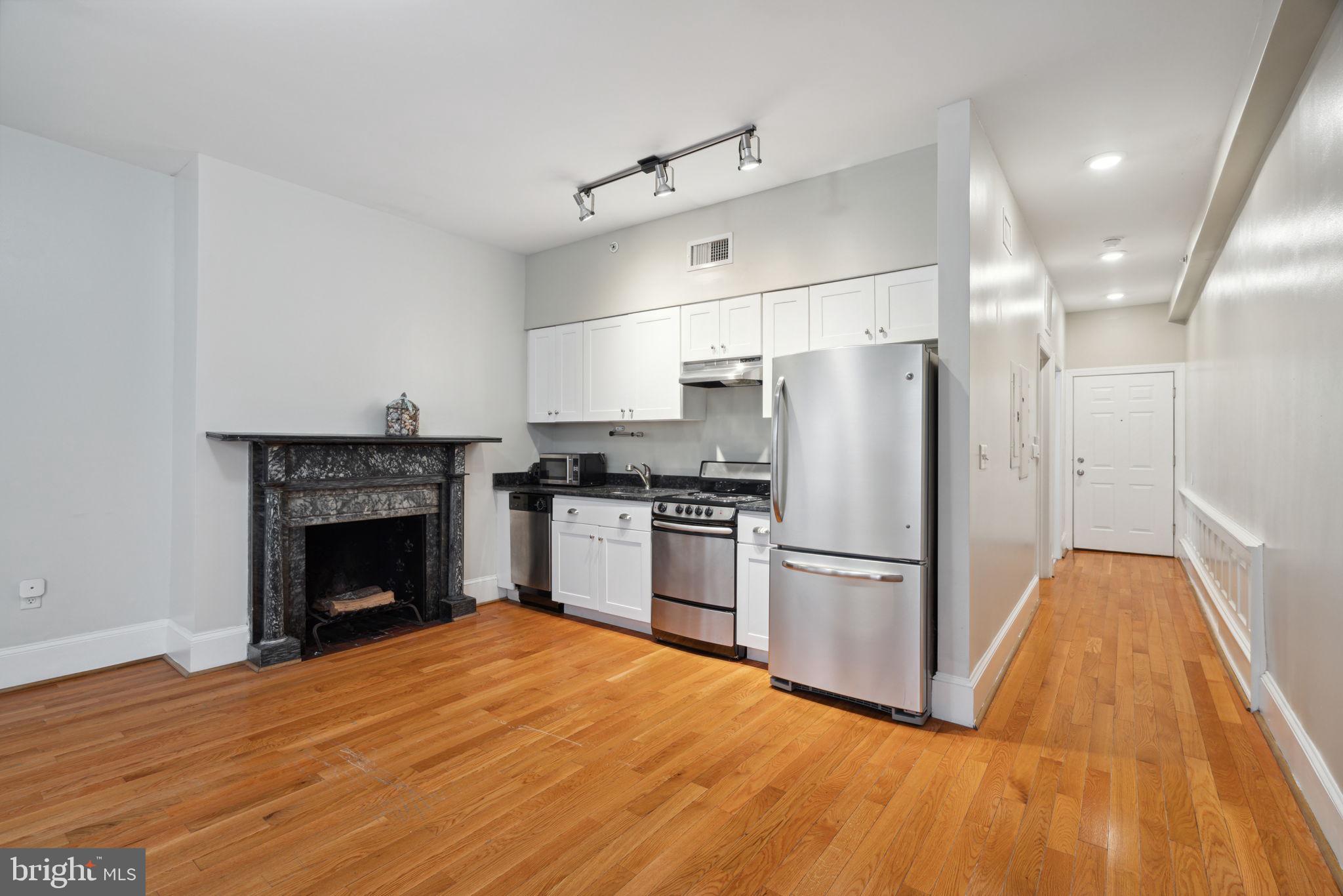 1955 Locust Street, Unit 2R Philadelphia, PA 19103 - Photo 3 of 19 a kitchen with a refrigerator and a stove top oven