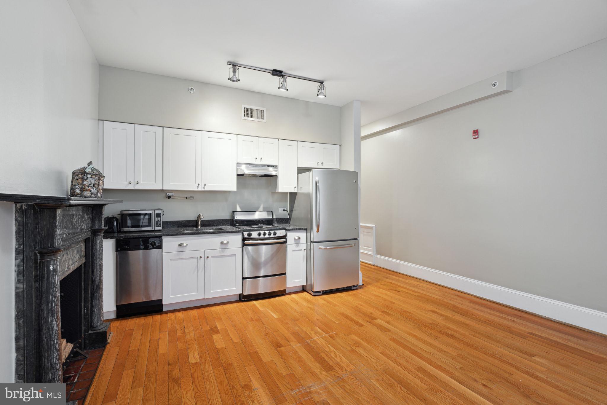 1955 Locust Street, Unit 2R Philadelphia, PA 19103 - Photo 4 of 19 a kitchen with stainless steel appliances a refrigerator and a stove top oven