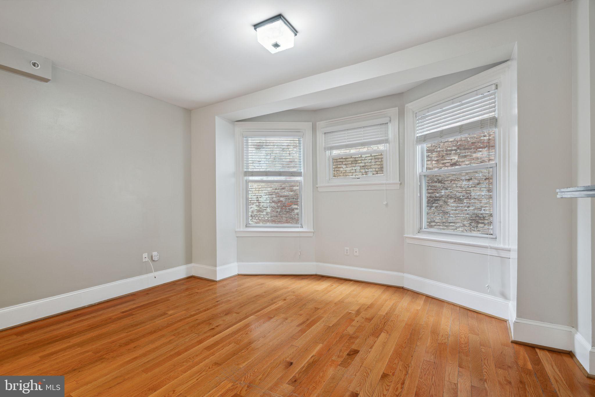 1955 Locust Street, Unit 2R Philadelphia, PA 19103 - Photo 5 of 19 a view of empty room with wooden floor and fan