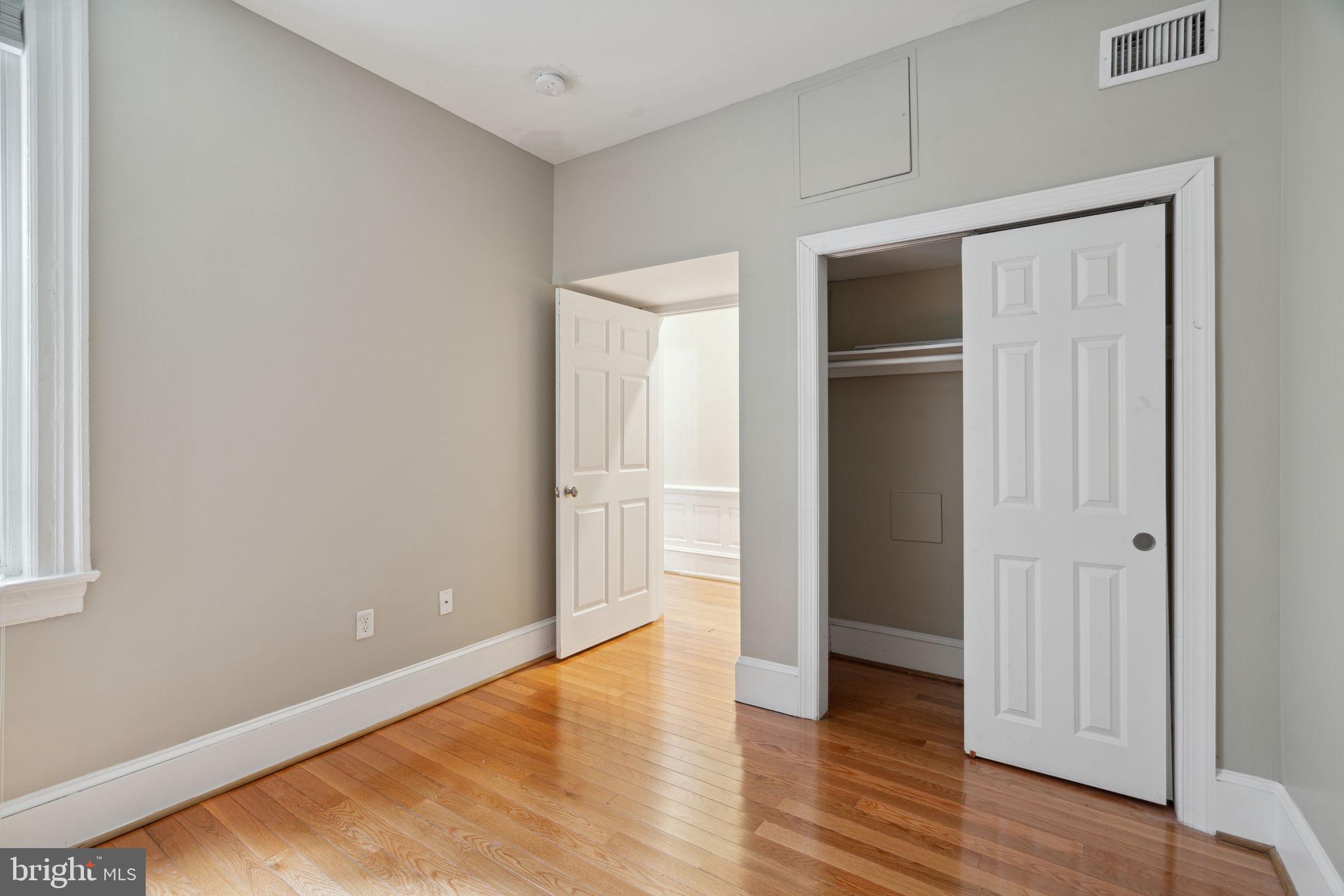 1955 Locust Street, Unit 2R Philadelphia, PA 19103 - Photo 10 of 19 a view of an empty room with wooden floor & closet