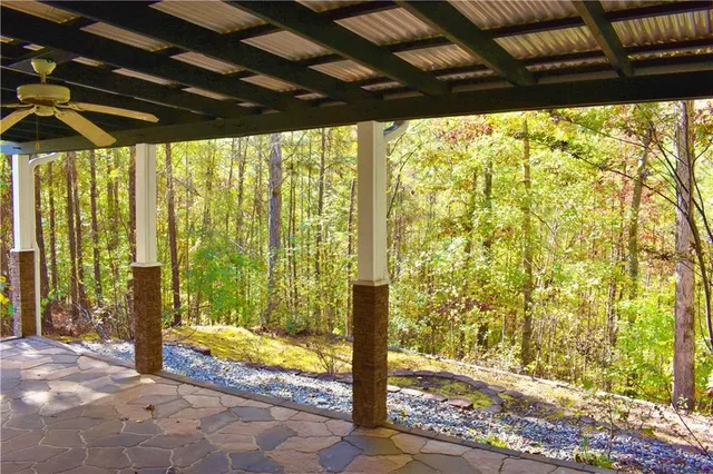 a view of porch with a bench and wooden floor