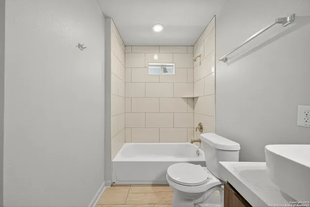 a bathroom with a toilet and a bathtub