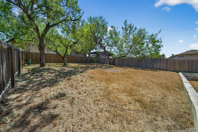 a view of a backyard of the house