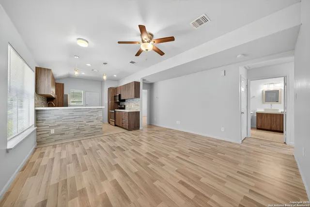 a view of a kitchen with a sink and a stove top oven