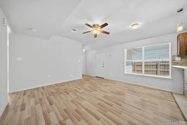 wooden floor in an empty room with a window