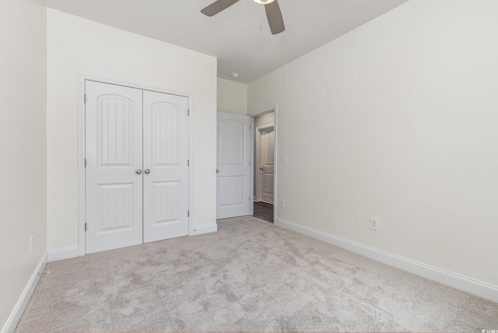 2104 Highway 9 Business Loris, SC 29569 - Photo 15 of 20 Unfurnished bedroom featuring carpet, a closet, and ceiling fan