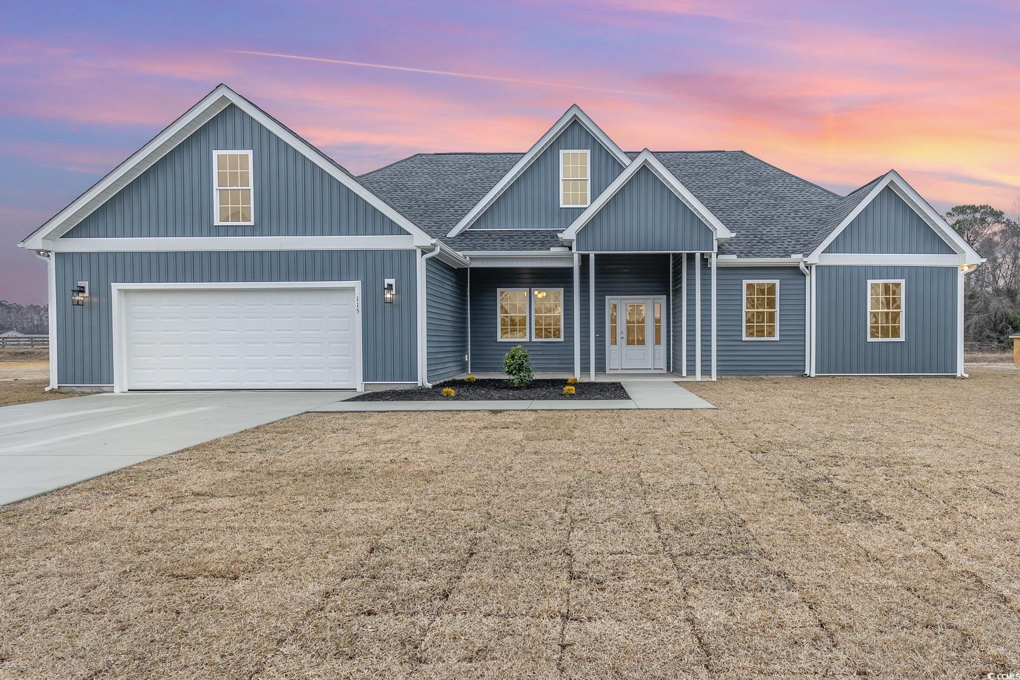 2104 Highway 9 Business Loris, SC 29569 - Photo 2 of 20 View of front of property featuring roof with shingles, driveway, covered porch, and a front yard