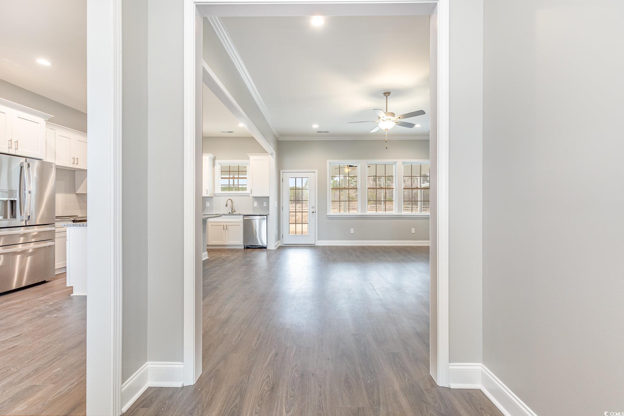 2104 Highway 9 Business Loris, SC 29569 - Photo 7 of 20 Unfurnished living room with crown molding, dark wood-style floors, recessed lighting, and ceiling fan