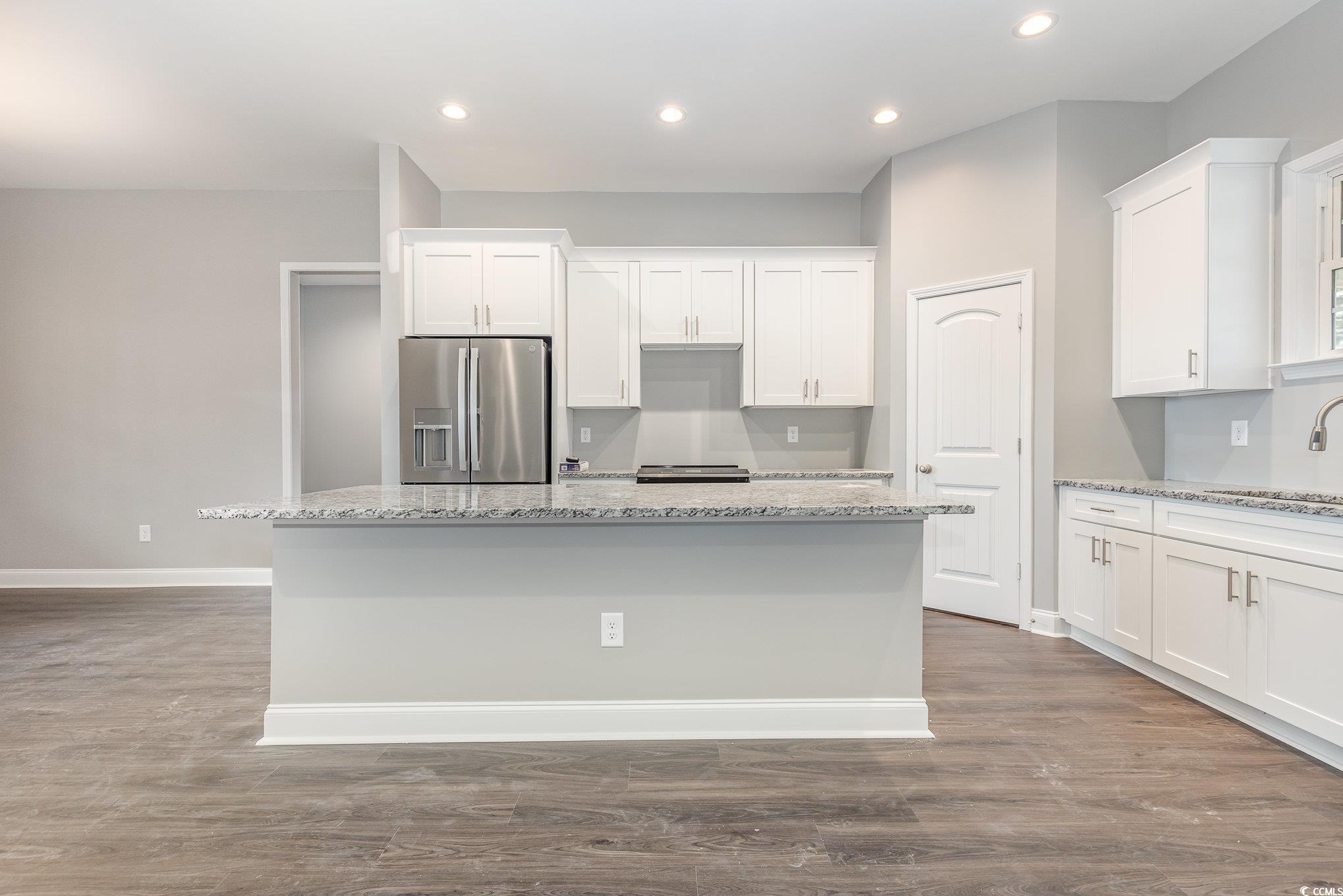 2104 Highway 9 Business Loris, SC 29569 - Photo 8 of 20 Kitchen featuring white cabinets, light stone counters, stainless steel refrigerator with ice dispenser, dark wood-type flooring, and recessed lighting
