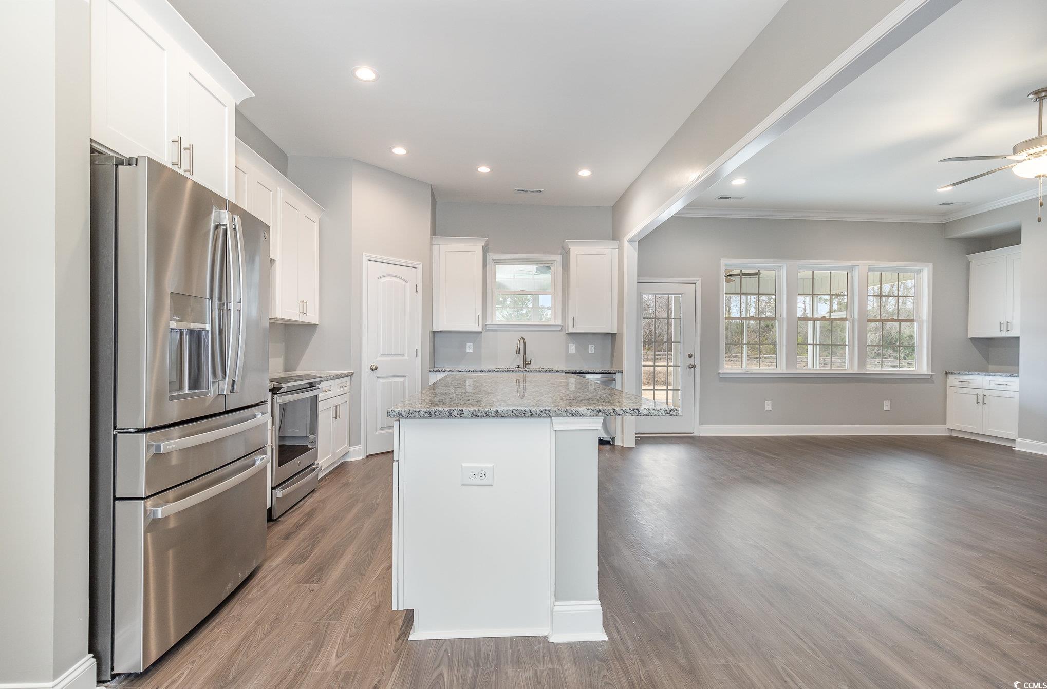 2104 Highway 9 Business Loris, SC 29569 - Photo 9 of 20 Kitchen featuring stainless steel appliances, white cabinets, healthy amount of natural light, dark wood-type flooring, and recessed lighting