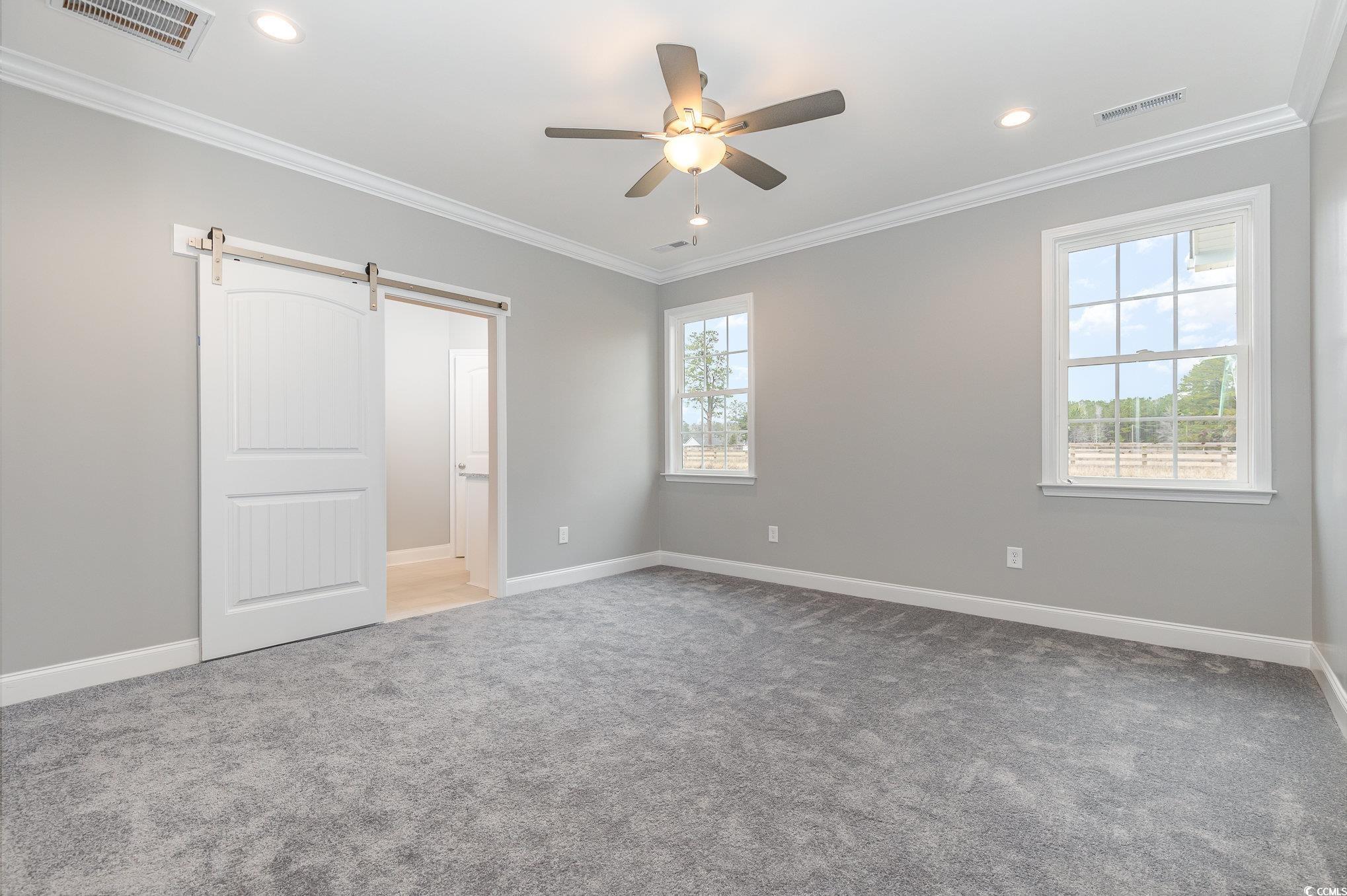 2104 Highway 9 Business Loris, SC 29569 - Photo 10 of 20 Unfurnished bedroom with a barn door, crown molding, light colored carpet, ceiling fan, and recessed lighting