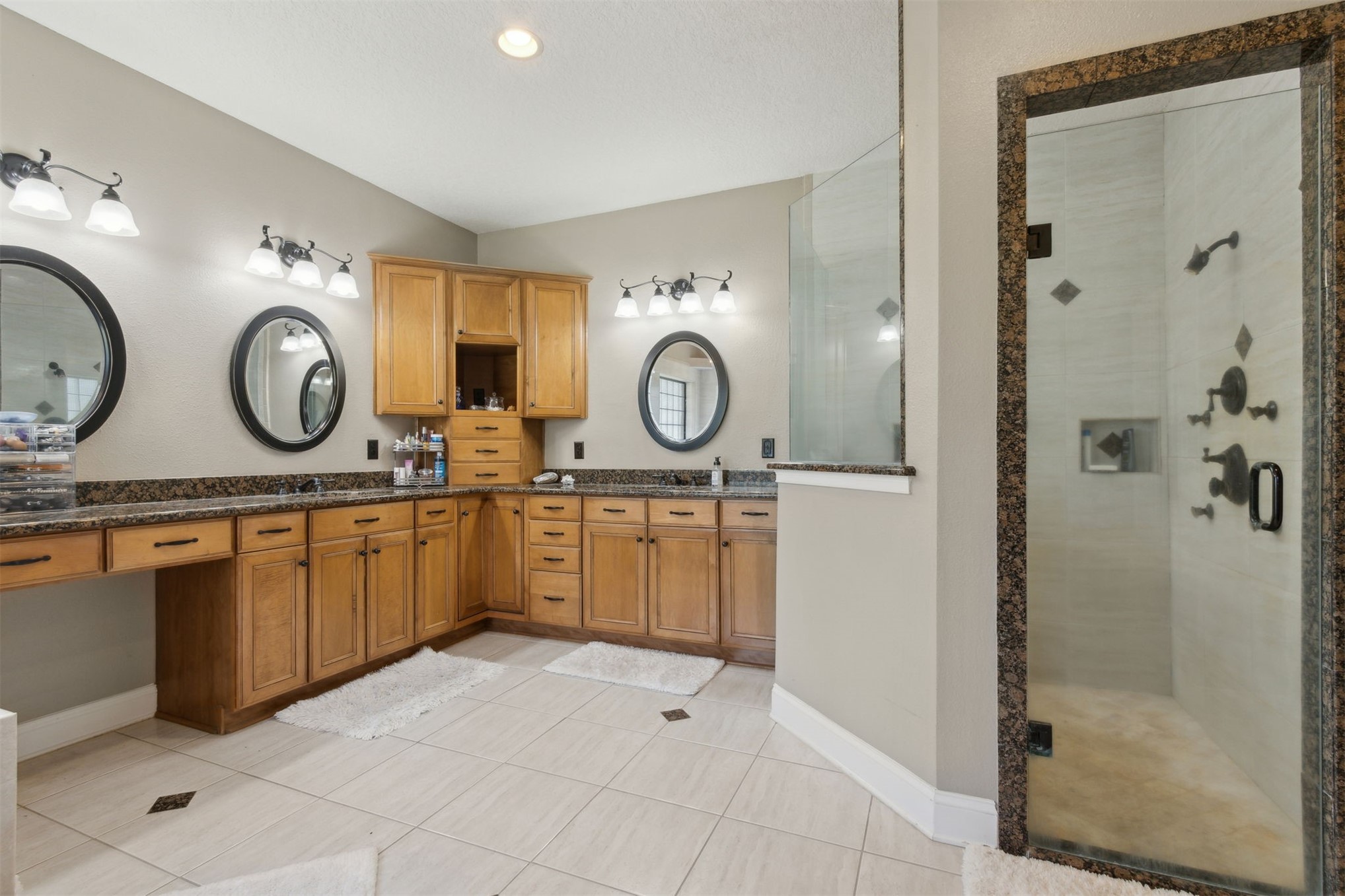 87377 Raddin Road Yulee, FL 32097 - Photo 43 of 75 a spacious bathroom with a double vanity sink and a mirror