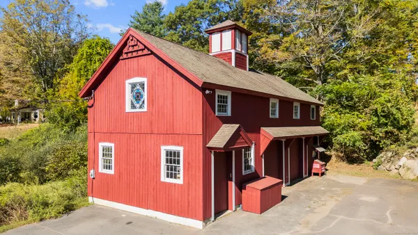 a view of a house with wooden fence