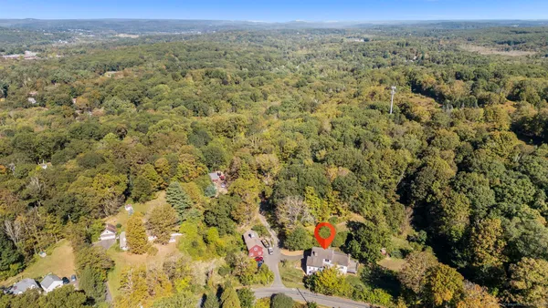 a view of a field with trees in the background