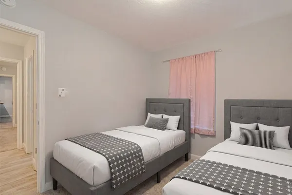 a bedroom with bed and a night stand