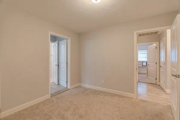 a view of an empty room and bathroom