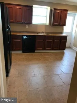 a kitchen with granite countertop a stove a sink and a microwave