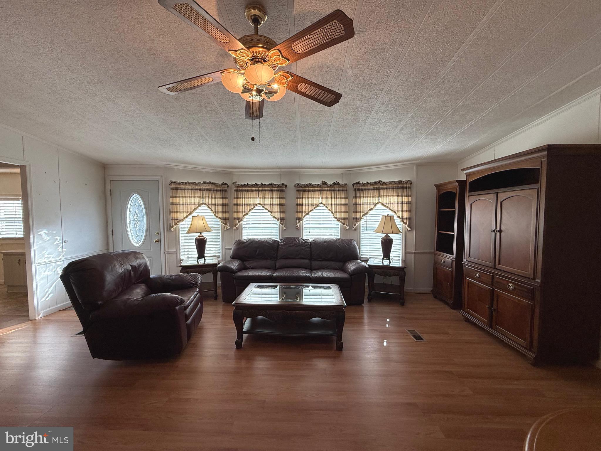 386 Indian Way Buena, NJ 08310 - Photo 11 of 53 a living room with furniture a window and a flat screen tv