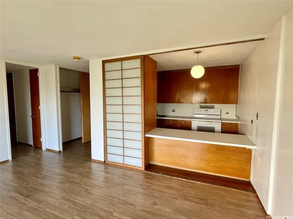 a view of a kitchen with a sink and a refrigerator