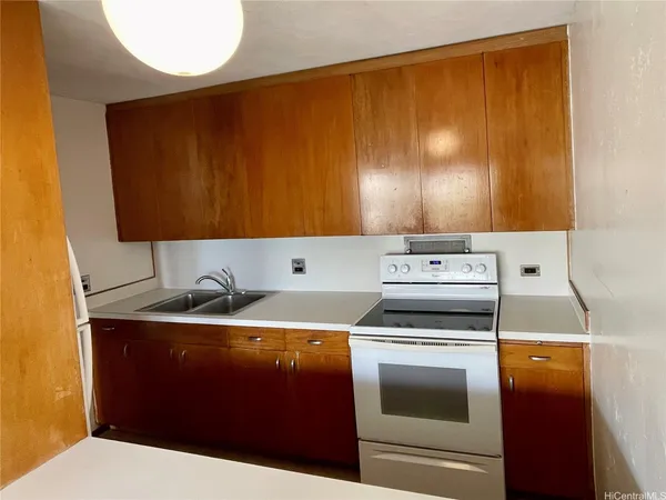 a kitchen with a sink a stove and cabinets