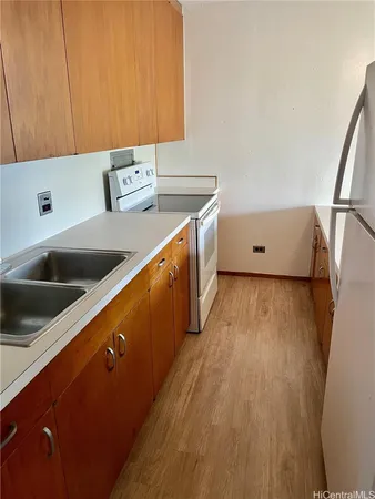 a kitchen with wooden cabinets and a sink