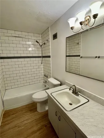 a bathroom with a sink mirror toilet and bathtub