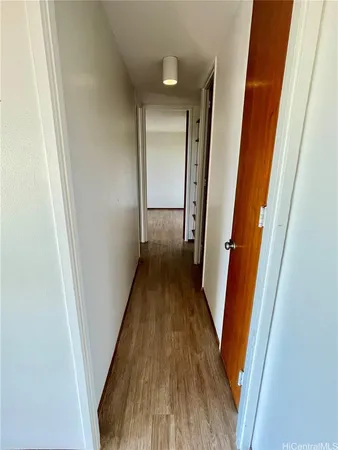 a view of a hallway and wooden floor
