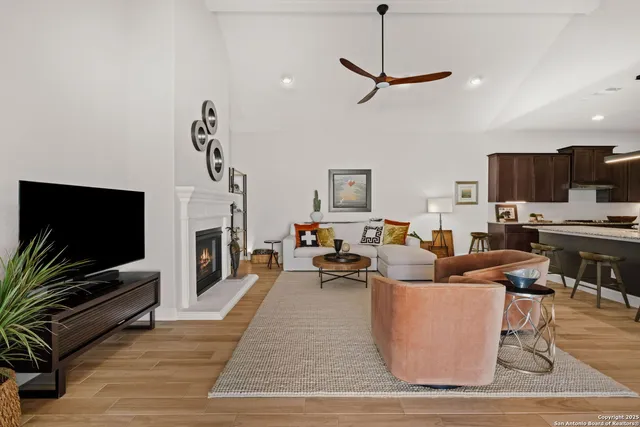 a living room with fireplace furniture and a flat screen tv