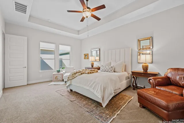 a bedroom with a bed couch and window