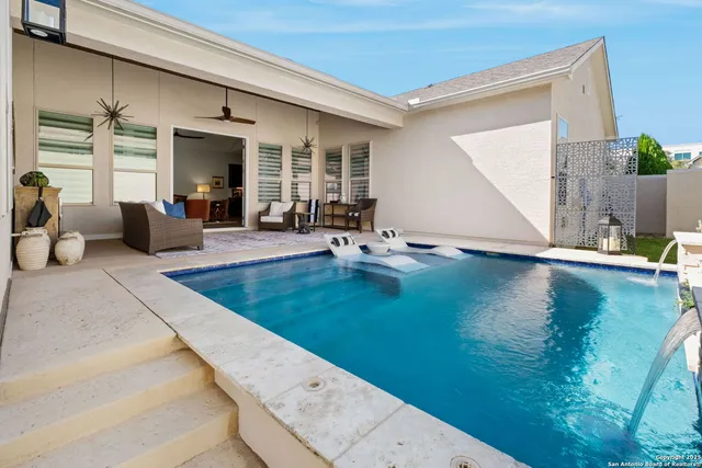 a view of a patio with dining table and chairs with wooden floor and plants